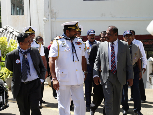 Navy Commander being accompanied by the principal and other guests